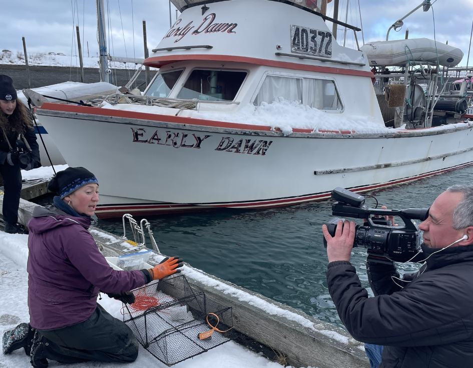 UAA students film Jasmine Maurer, the harmful species lead at KBNERR as she checks her crab traps in the Homer harbor