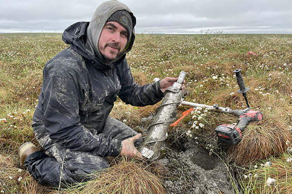 Researcher Ben Jones collects samples in the Arctic tundra